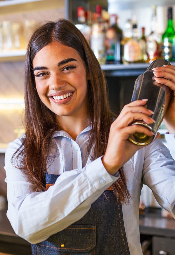Female worker at bartender desk in restaurant
