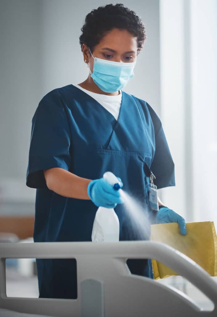 Worker Wiping the Hospital Bed